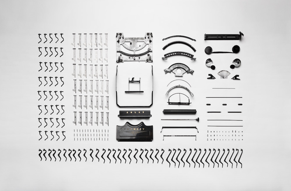 all the parts of a machine (like a brain) laid out on a white background